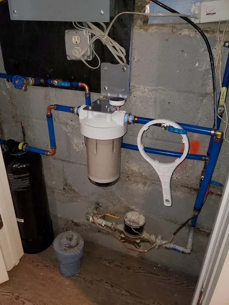 Main service line entering a basement with new valves and fittings in Clifton, NJ